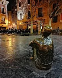 Niño sentado mirando la Torre Nueva.